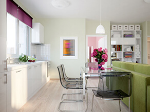 Pastel_Green_Kitchen_White_countertop_cabinets_clear_grey_table_chairs_pink_flowers_couch